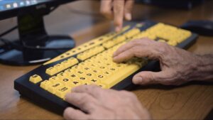 Keyboard with large yellow keys and large print letters and numbers